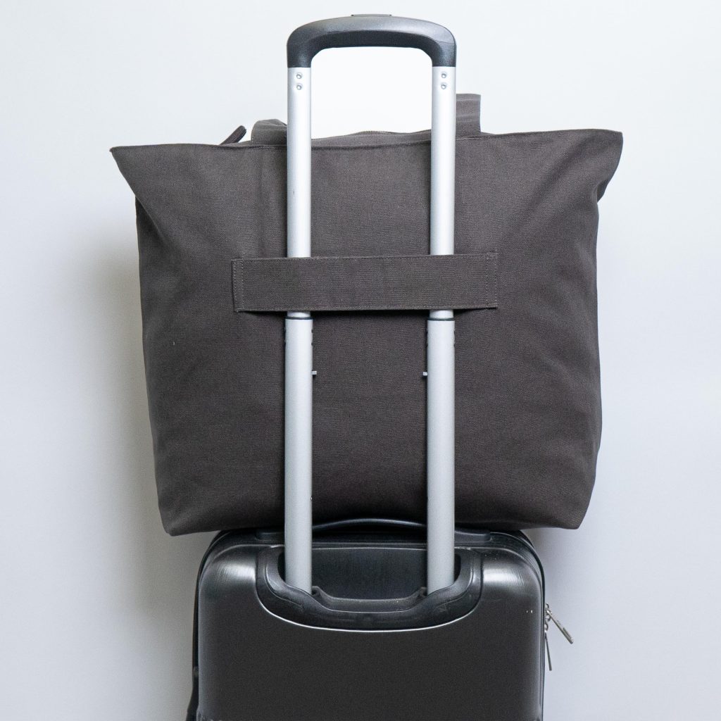 Travel tote bag with trolley sleeve